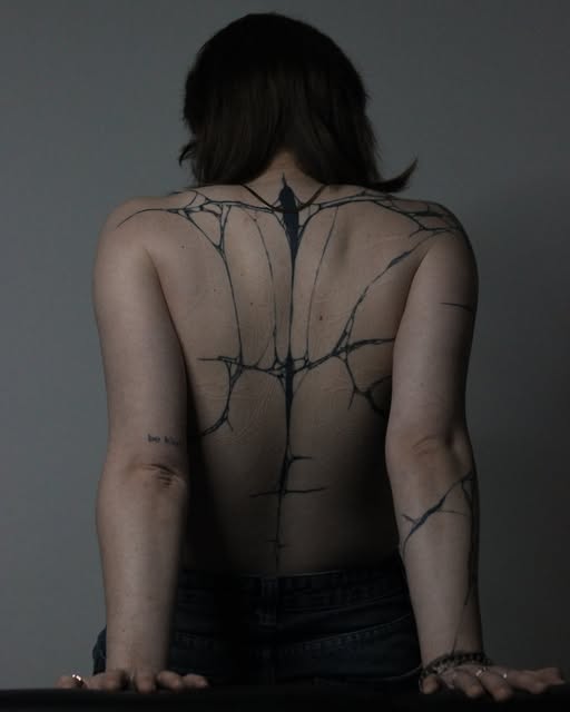 Abstract crack-like line work across the back by Zuzana Mala